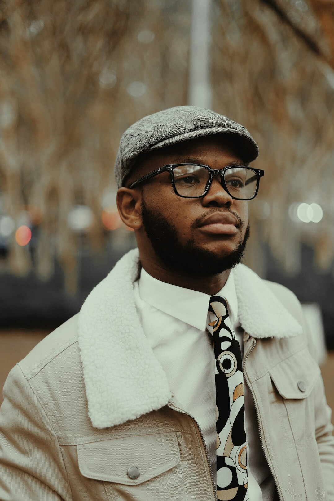 Portrait of a man with glasses and a beard in a business casual outfit