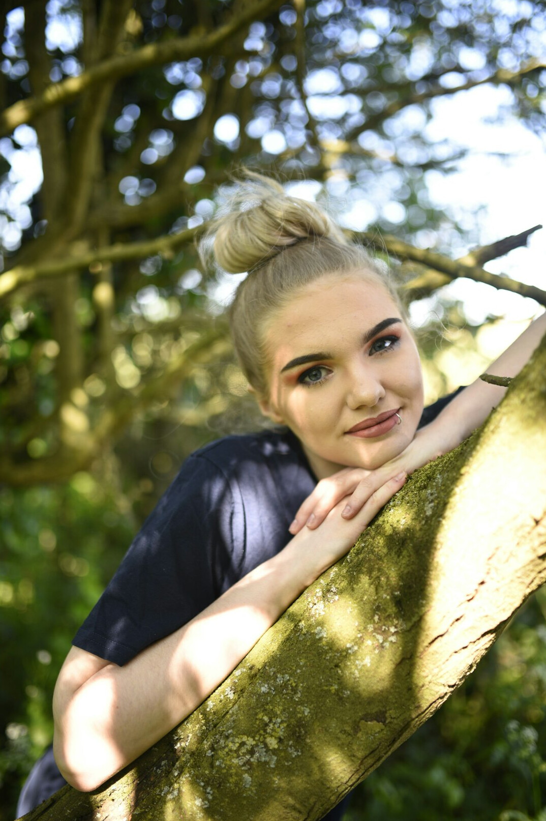 Portrait of a young woman with blond hair smiling at the camera