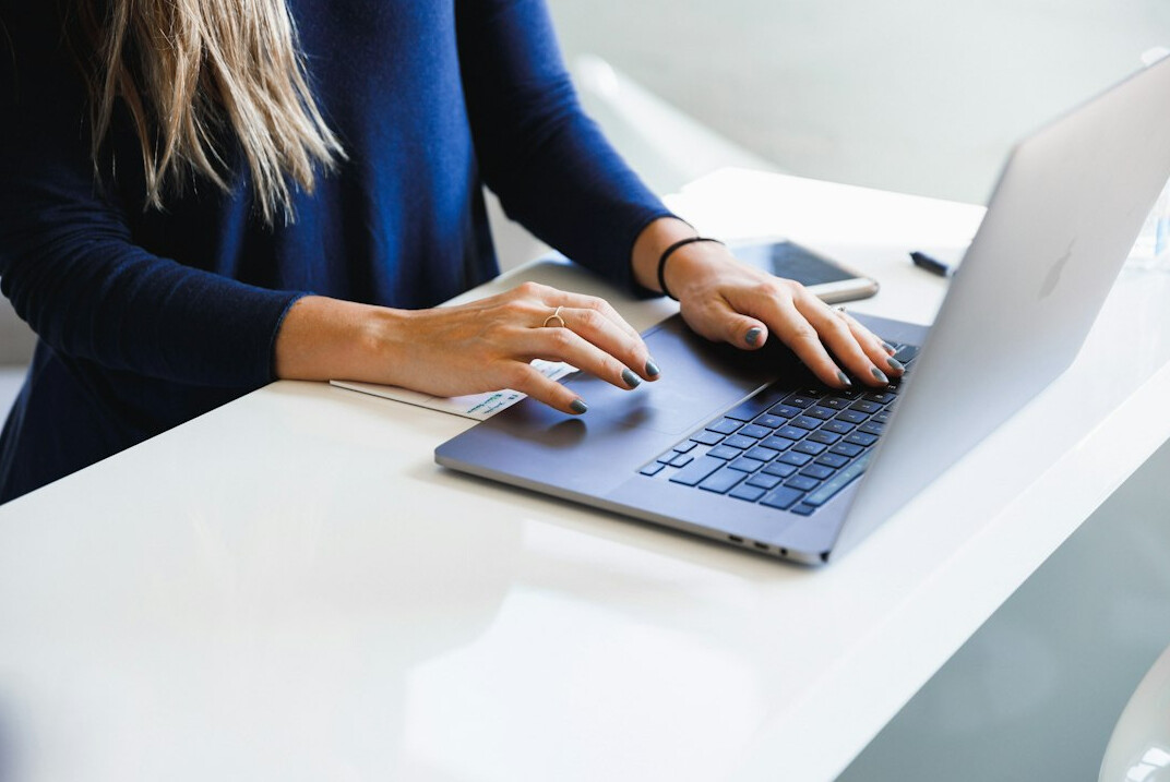 woman returning to laptop after break